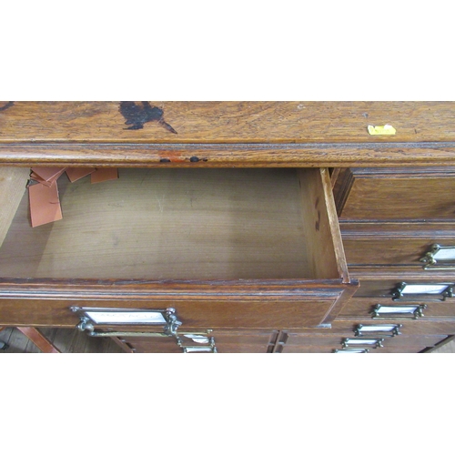 28 - An oak set of drawers, consisting of two banks of eight drawers, 36ins x 14.5ins, height 42ins