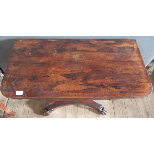 32 - A 19th century rosewood fold over games table, on turned column, to platform base with paw feet, wid... 