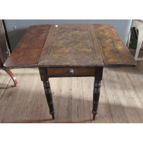 33 - An oak drop leaf table, the top with parquetry decoration, fitted with end drawer, raised on turned ... 