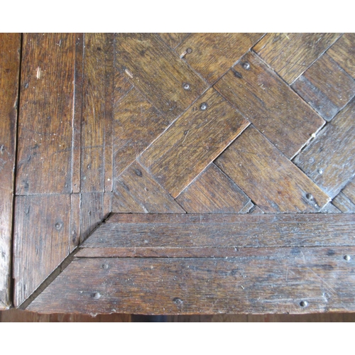 33 - An oak drop leaf table, the top with parquetry decoration, fitted with end drawer, raised on turned ... 