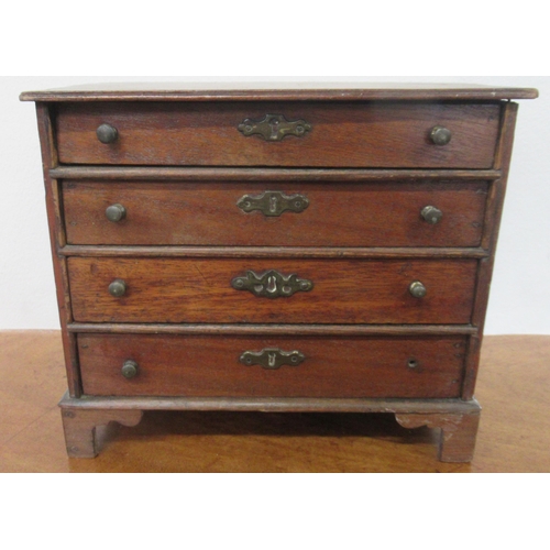 4 - A miniature chest, of four long drawers, 9ins x 4.75ins, height 8ins