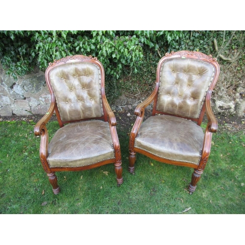 41 - A pair of 19th century mahogany open arm chairs with leather seat and back raised on reeded turned l... 