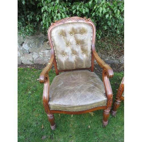 41 - A pair of 19th century mahogany open arm chairs with leather seat and back raised on reeded turned l... 