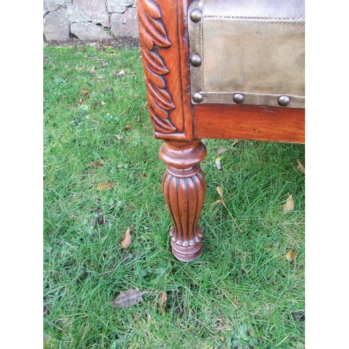 41 - A pair of 19th century mahogany open arm chairs with leather seat and back raised on reeded turned l... 