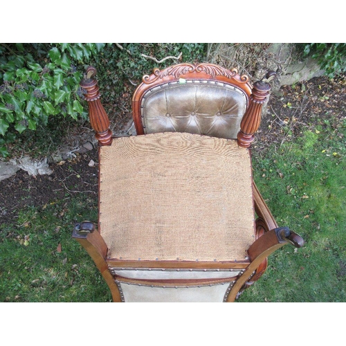 41 - A pair of 19th century mahogany open arm chairs with leather seat and back raised on reeded turned l... 