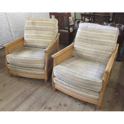 45 - A pair of Ercol bergere and upholstered armchairs