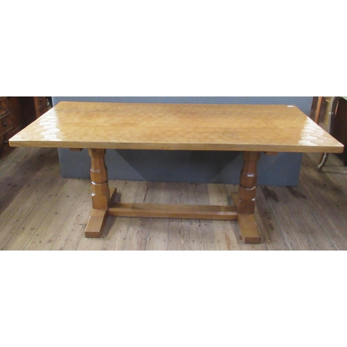 54 - A 1970's Robert Thompson Mouseman oak refectory dining table, with adze top, raised on end supports ... 