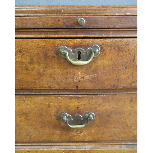 56 - An Antique walnut chest, fitted with a brushing slide over two short and three long graduated drawer... 