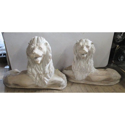 57 - A pair of carved wooden recumbent lions, height 32ins, width 40ins