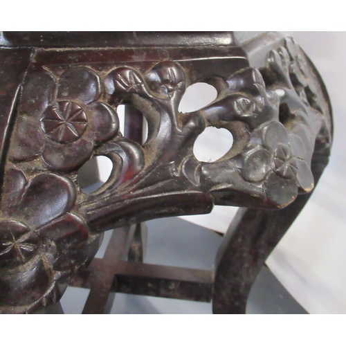 8 - An Eastern ebonised plant stand, with marble inset into the octagonal top, with pierced and carved d... 