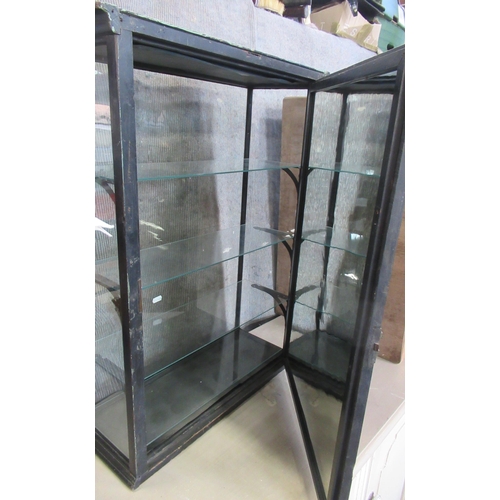 9 - An ebonised display cabinet, with mirrored back and three glass shelves, with hinged door to the bac... 