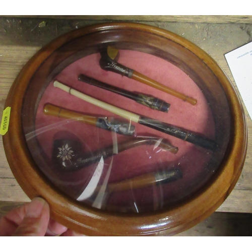 A collection of framed cheroot holders