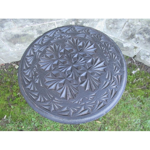 42 - A circular occasional table, with carved decoration, raised on 3 legs, width 16ins, height 24ins