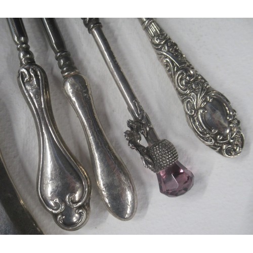 A collection of button hooks, some with silver handles