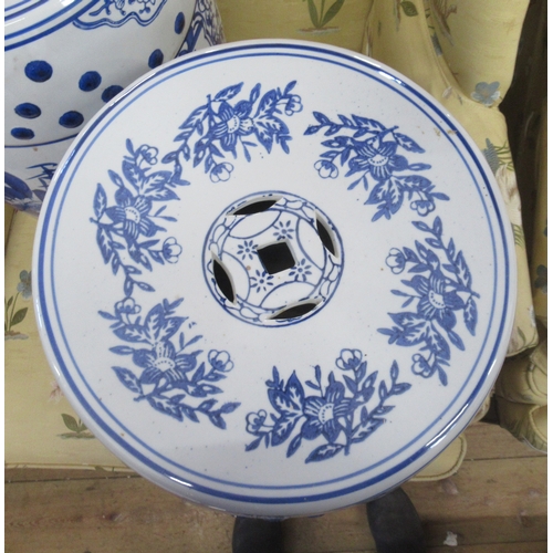 2 - A pair of pottery garden seats, of barrel form, decorated in blue and white