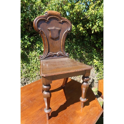 48 - An Edwardian center table together with a hall chair