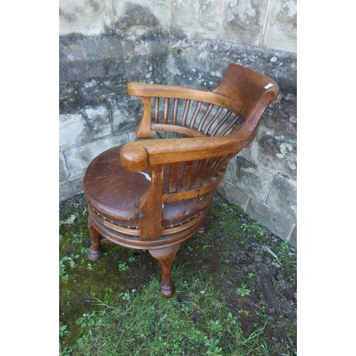 16 - An oak office chair, with leather seat