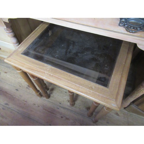 32 - A pine dressing table, chest of drawers and a nest of tables