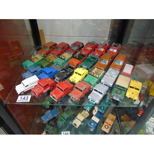 143 - Shelf diecast Landrovers etc