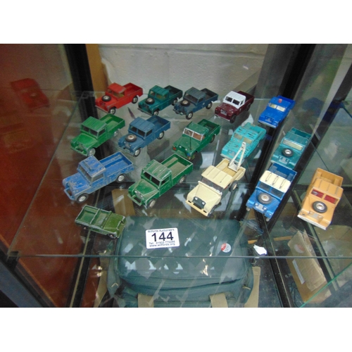 144 - Shelf diecast Landrovers etc