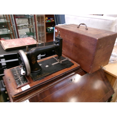 113 - Cased singer sewing machine.