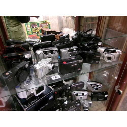 126 - Shelf cameras, lenses etc