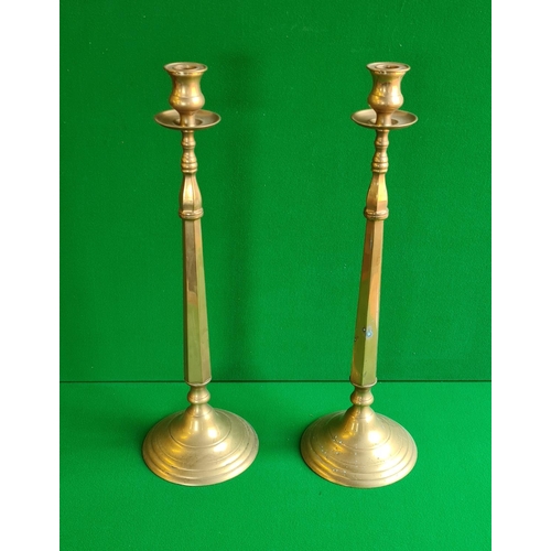146 - Pair of Victorian tall brass candle sticks standing 57 cm high.