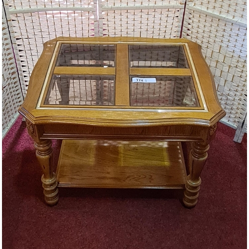 174 - Modern coffee table having 4 glass inset panels and lower shelf. Measures approx. 60x70x62 cm