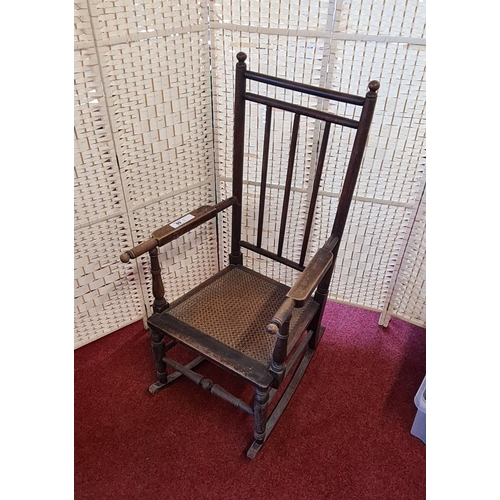 99 - A dark wood bergère seated rocking chair