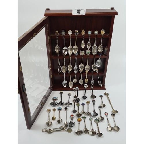 47 - Large amount of souvenir tea spoons and a glazed collectors display case