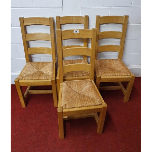 59 - 4 heavy and good quality light oak ladder back dining chairs with strung seats