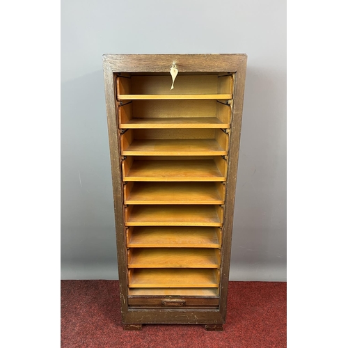 143 - An oak cased tambour fronted filling cabinet,  complete with key.115x46x46cm Collection only or plea... 