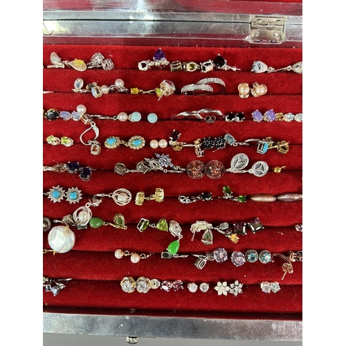 197 - Large amount of earrings, majority stamped .925 and contained in a pretty white metal display case h... 