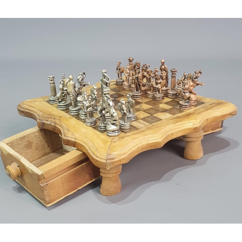 198 - Unusual chess set and board, raised on squat supports and having two opposing drawers. 20x20cm. Ship... 