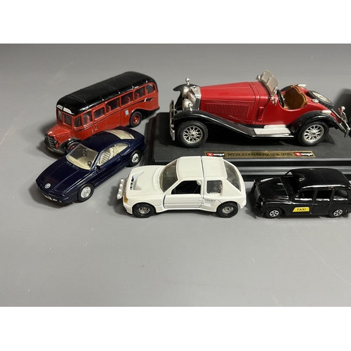 10 - A selection of die cast toy model vehicles including Burago Mercedes SSK, Morris Minor, London black... 