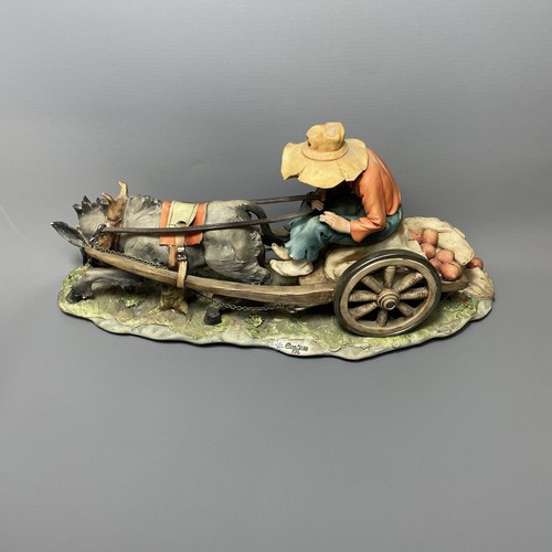 51 - Capodimonte boy on donkey cart, signed Cortese 336. In good order with no visible signs of damage or... 