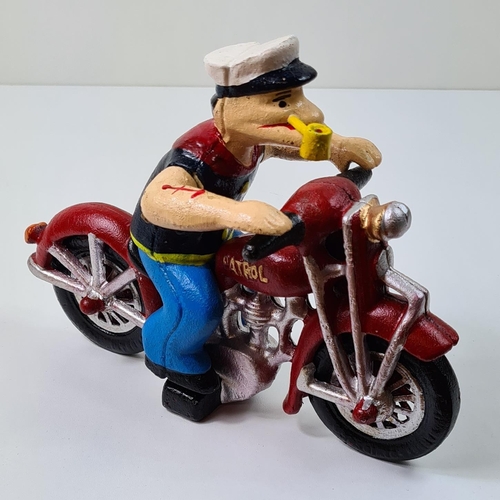 35 - Cast metal figure of Popeye on a motorcycle. Measuring 16cmx22cm. Shipping group (A), optional combi... 