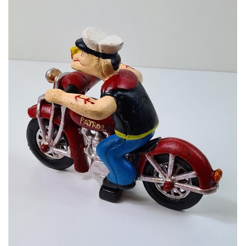 35 - Cast metal figure of Popeye on a motorcycle. Measuring 16cmx22cm. Shipping group (A), optional combi... 