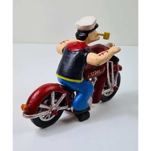 35 - Cast metal figure of Popeye on a motorcycle. Measuring 16cmx22cm. Shipping group (A), optional combi... 