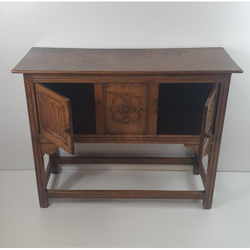 53 - Antique oak raised sideboard of small proportions, having carved centre panel flanked by carved door... 