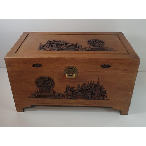 70 - A large and very well made hardwood trunk with key. Decorated with carved Oriental scenes. 59x100x92... 