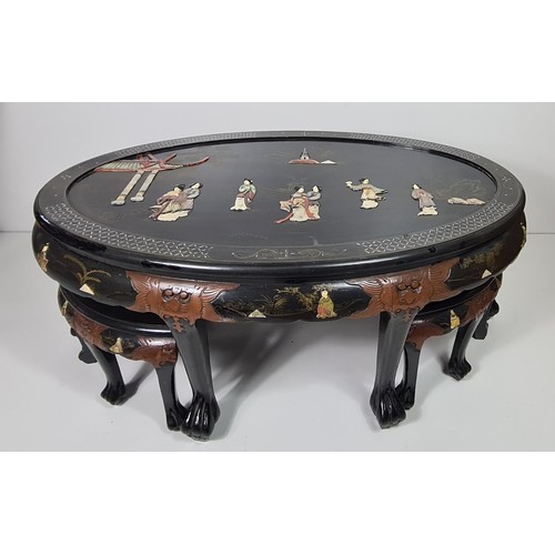 75 - A fine Oriental black lacquered coffee table with four stools under. Hand decorated with C19th scene... 