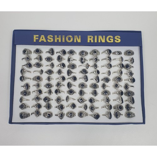 17 - 100 white metal fashion rings in retail display box. Shipping Group (A).