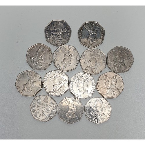 107 - 13 Beatrix Potter 50p coins. Shipping Group (A).