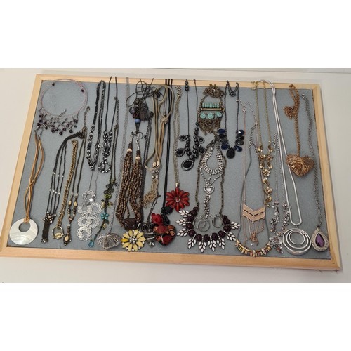 67 - Large quantity of necklaces (board not included). Shipping Group (A).