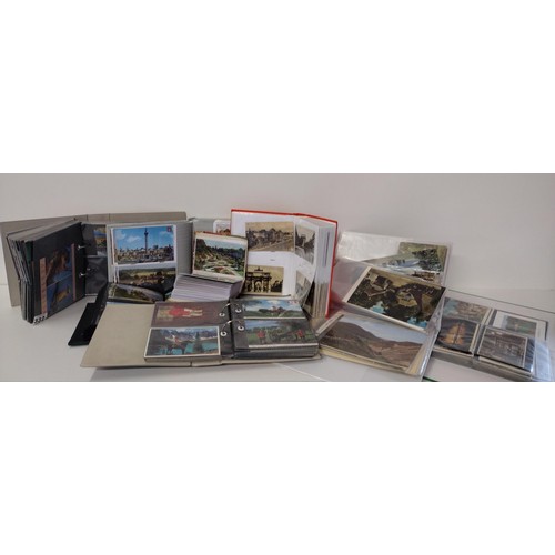 332 - Large assortment of postcards in albums. Shipping Group (B).