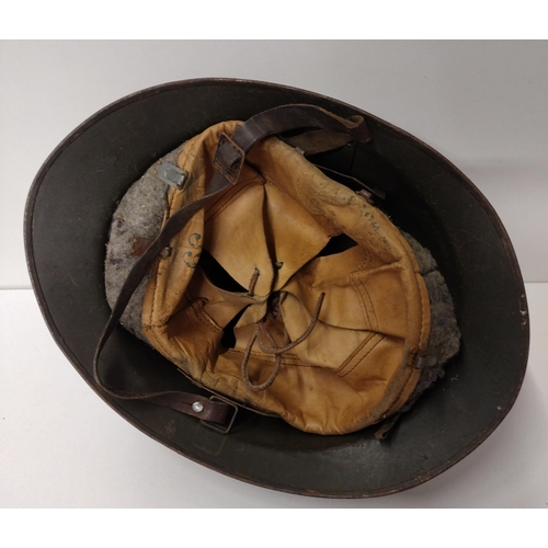 171 - WWI French Adrian helmet featuring artillery insignia with liner and strap. Shipping Group (A).