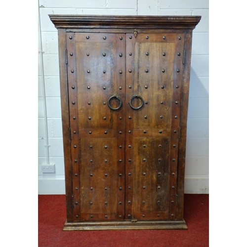 249 - A very good and attractive rustic style wardrobe having studded doors with ring-pull iron handles, o... 