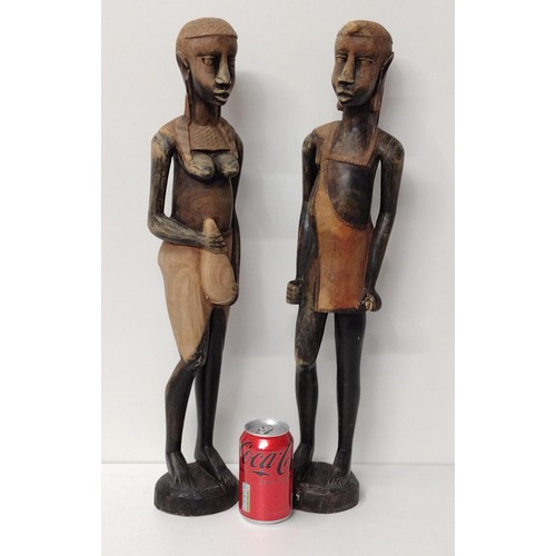 258 - (2) very tall ethnic carved wooden statues measuring 60cm  Shipping Group (A).