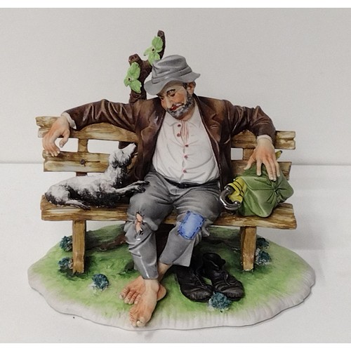 260 - Capodimonte figure of a Tramp on Bench with Dog, signed Tori Cigano. Shipping Group (A).